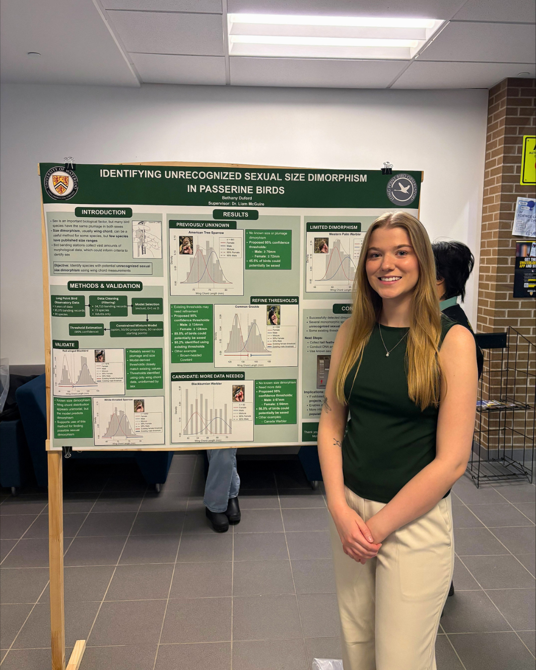 Bethany standing next to her research poster 