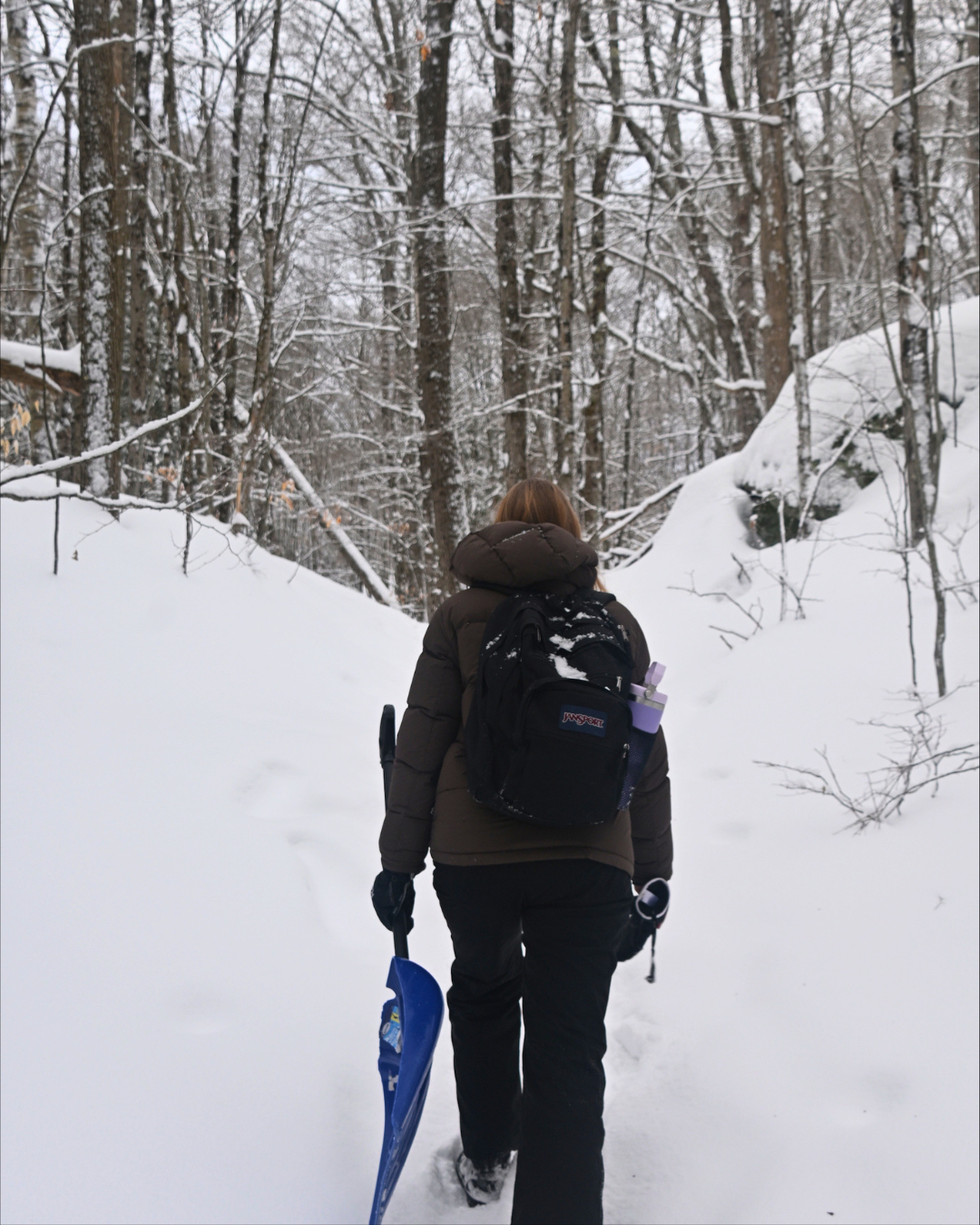 Bethany walking outside in the winter on a trail 