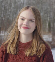 Profile photo of Brianna Thomas with a red sweater and snow in the background
