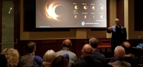 Avery Broderick presents images of black holes to a audience.