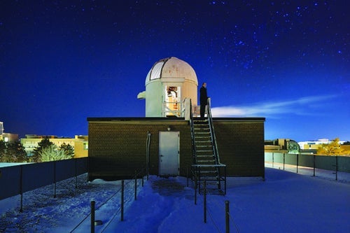 A visitor observing the skies from the rooftop