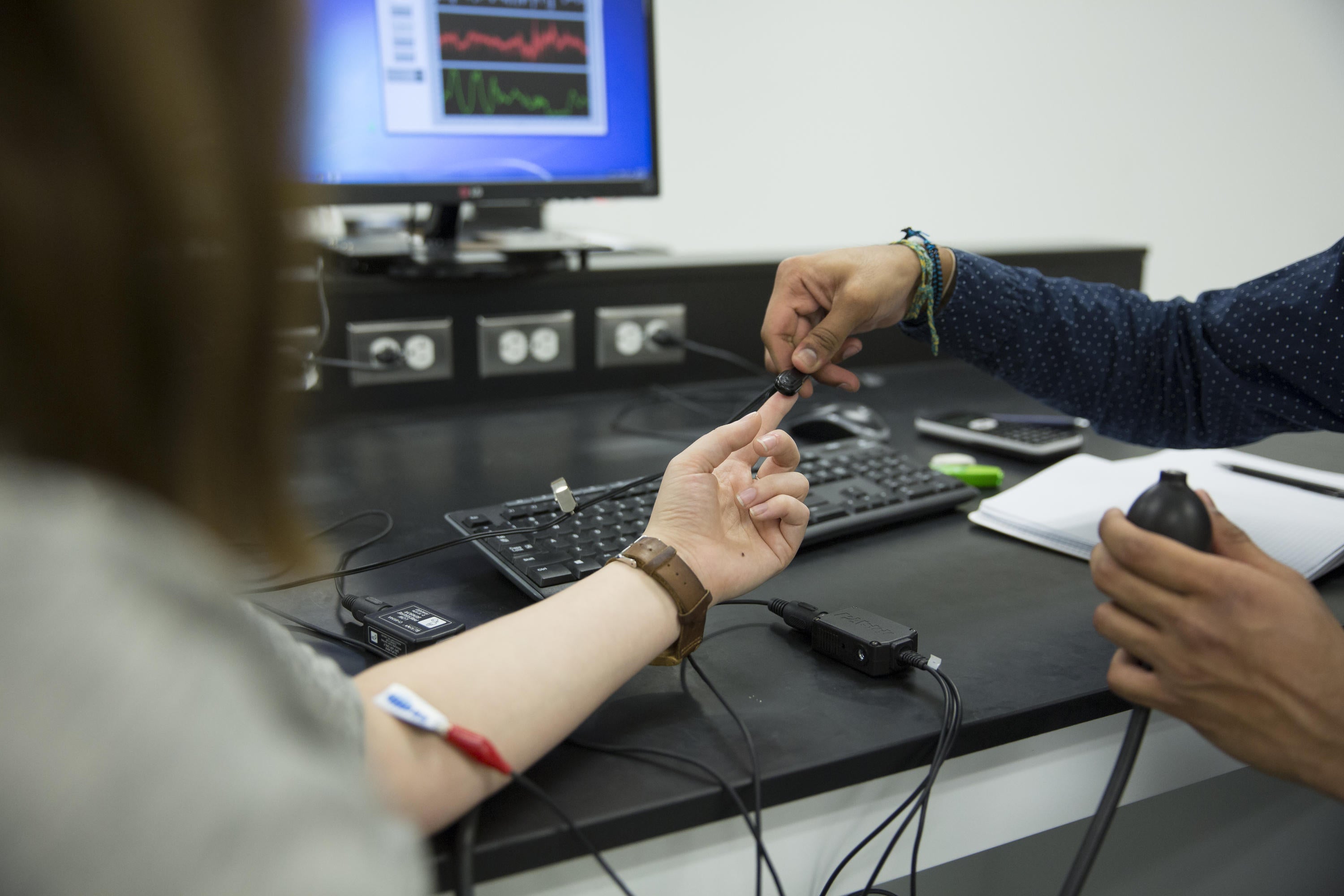 Student using finger sensor in lab