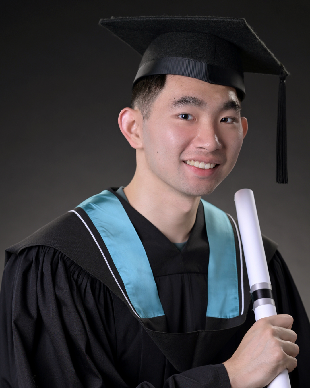 A graduation photo of Daniel in a cap and gown.