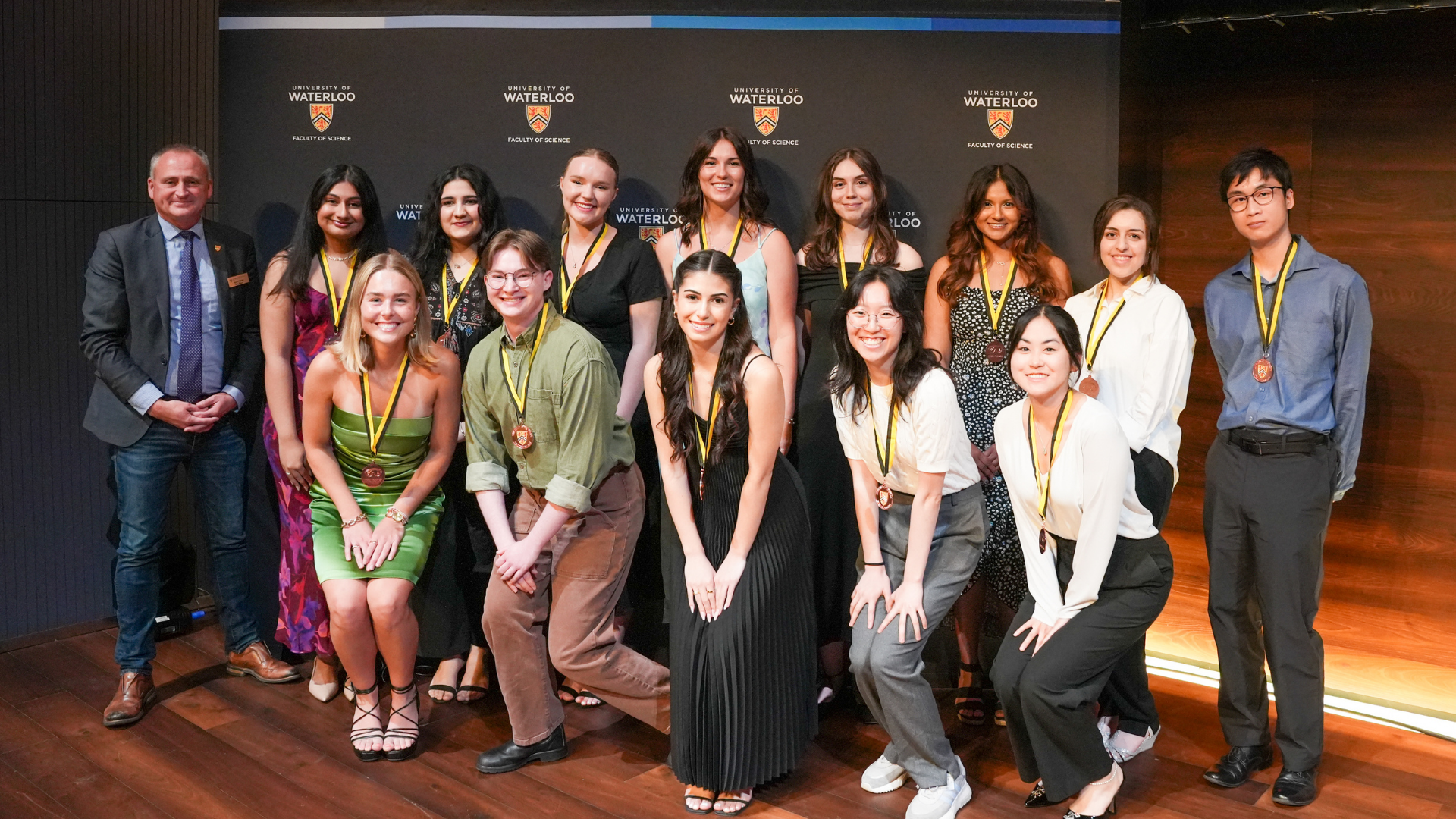 Dean Chris Houser standing next to a group of bronze IDEAL Scholar students.