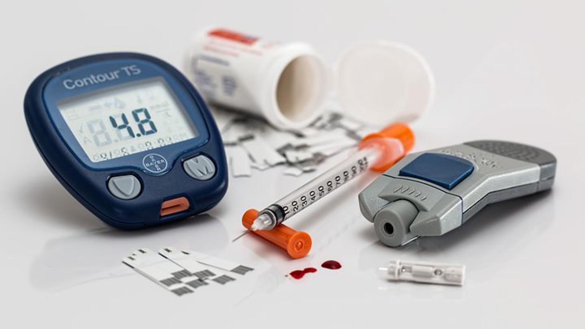Stock image of diabetes medications and blood sugar testing machines.