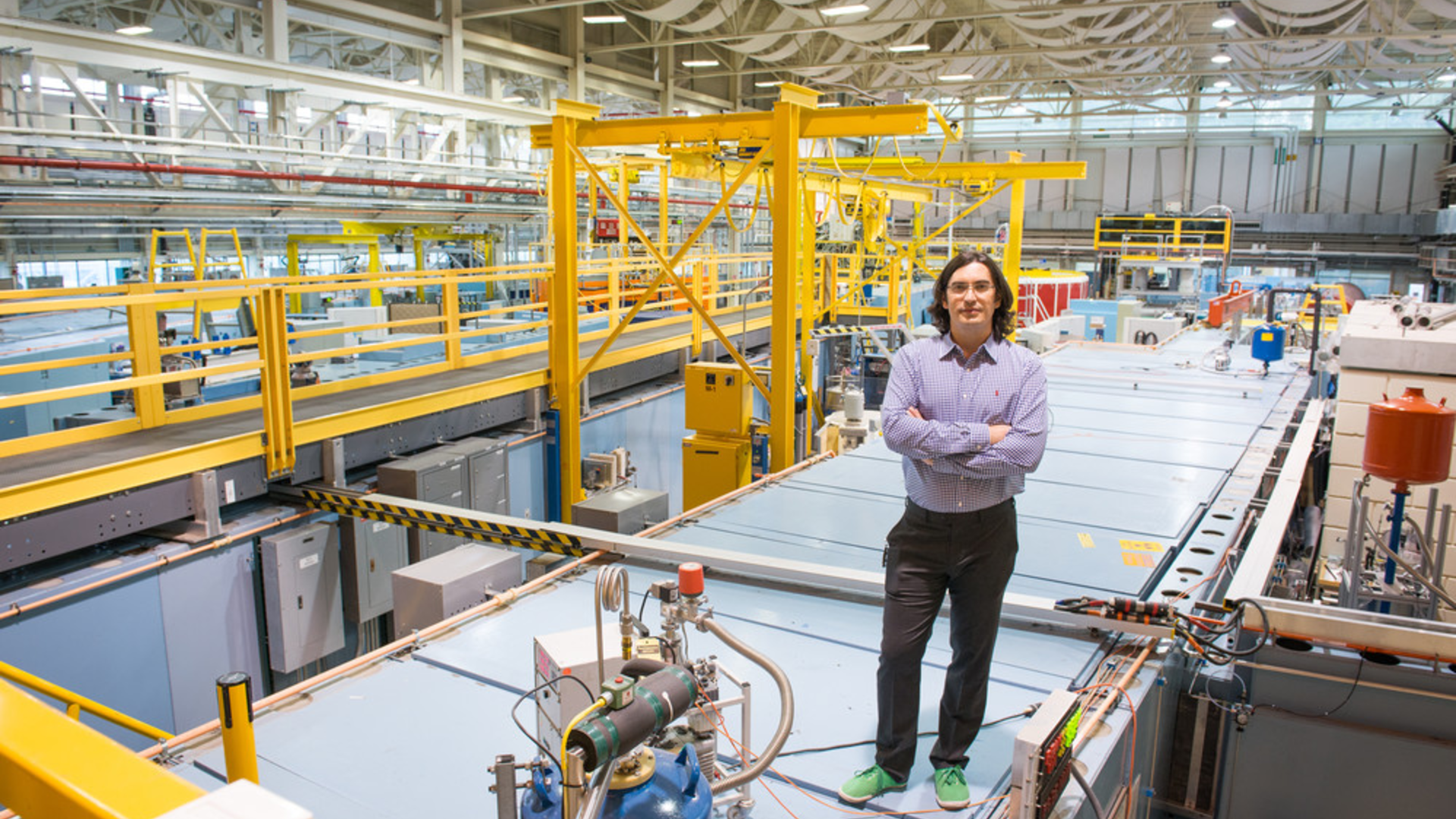 Professor Dmitry Pushin standing in an industrial looking lab space
