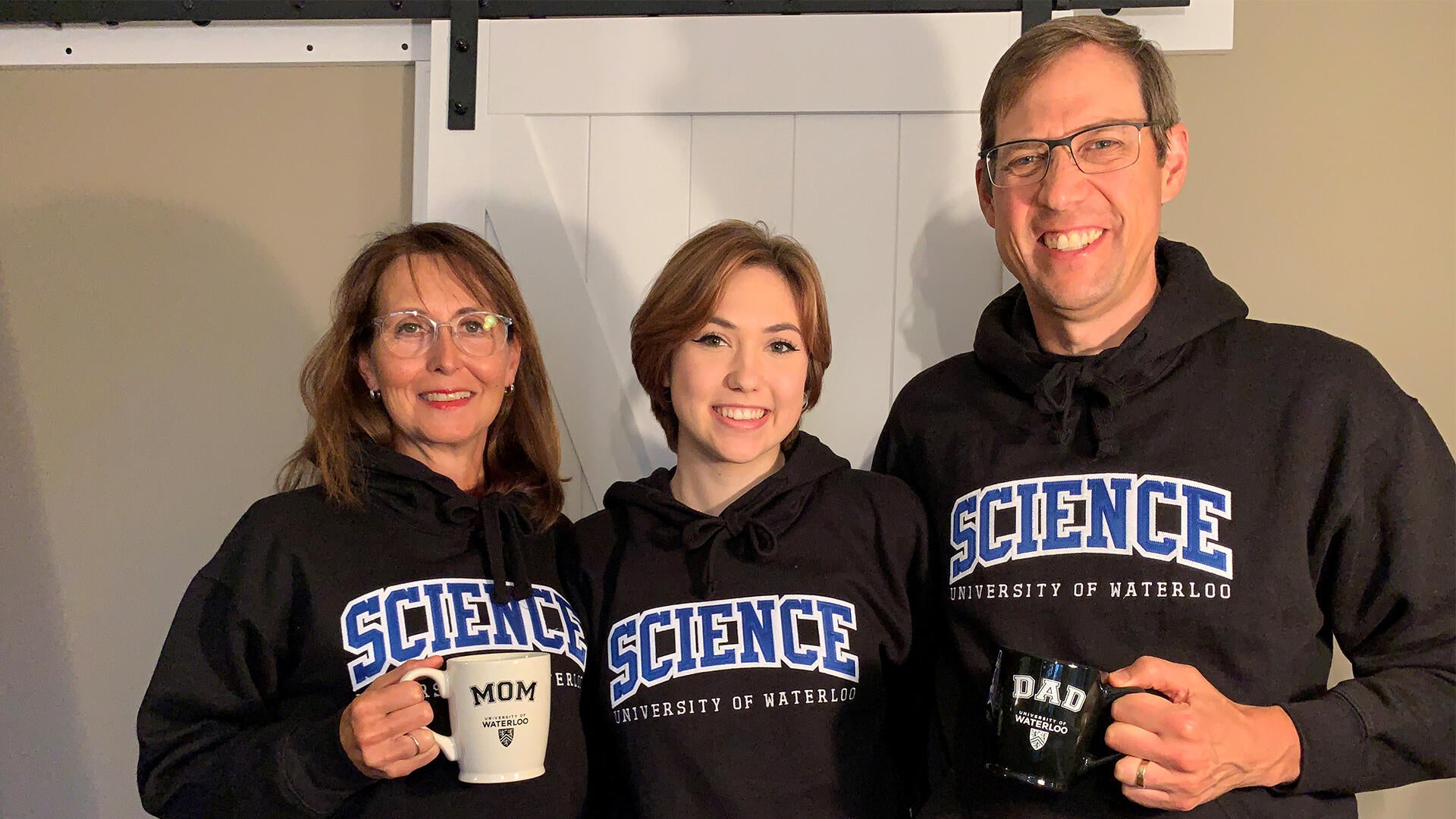 Jocelyn Hadden with her parents Susan and James, all in Waterloo Science sweaters.