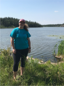 Hannah Thibault standing beside a lake
