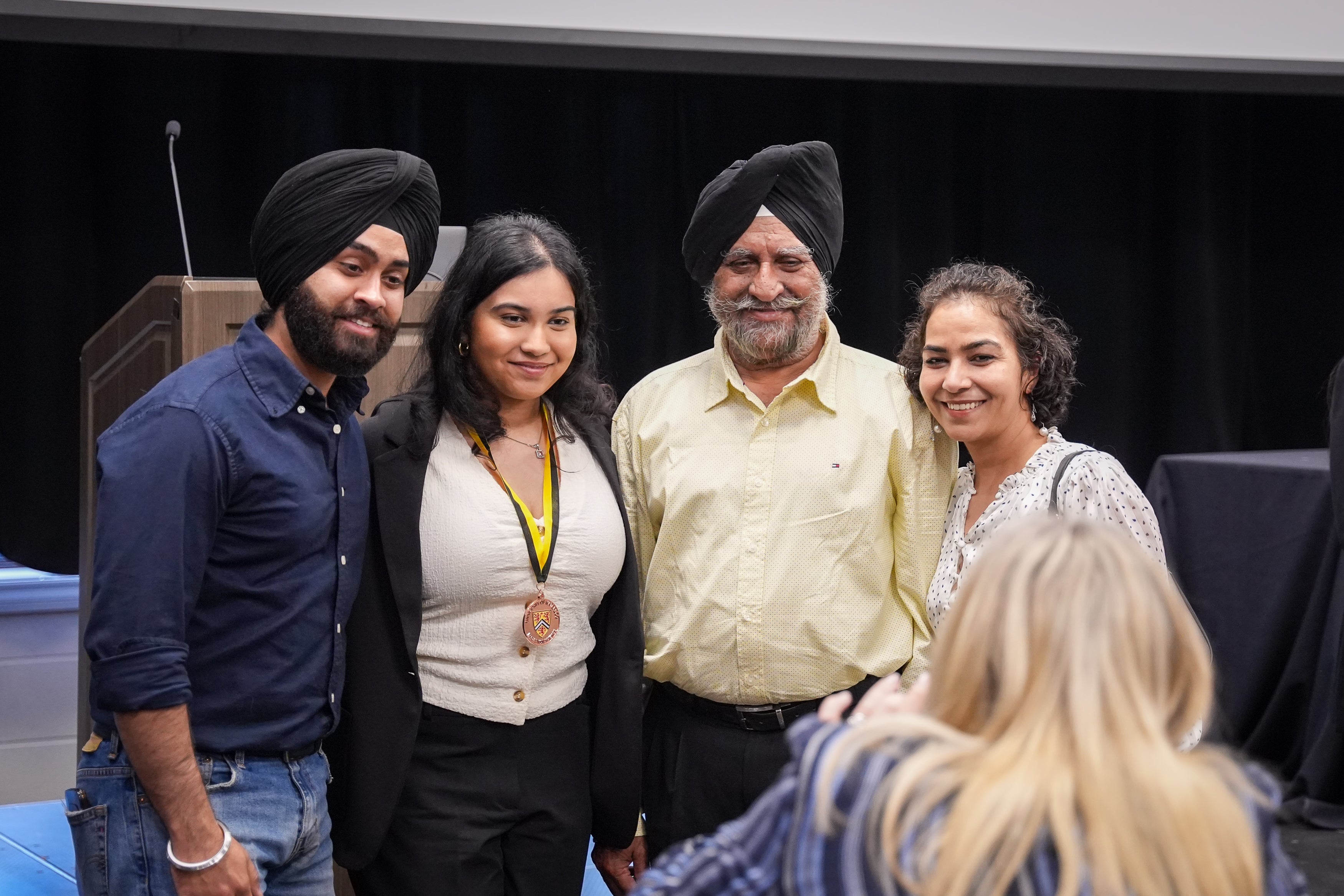 Family posing for a picture at IDEAL ceremony.