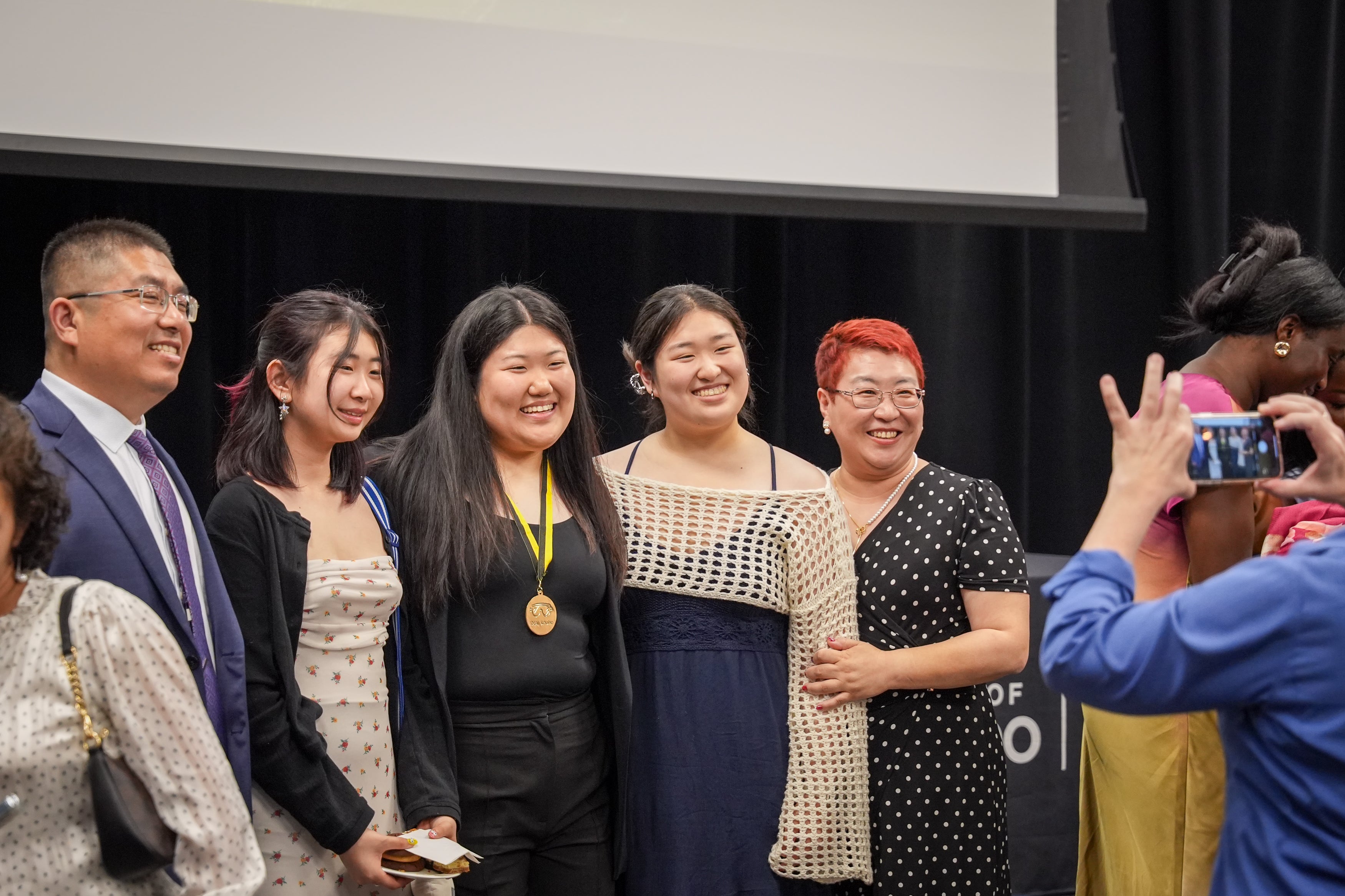 Family posing for a picture at IDEAL ceremony. 