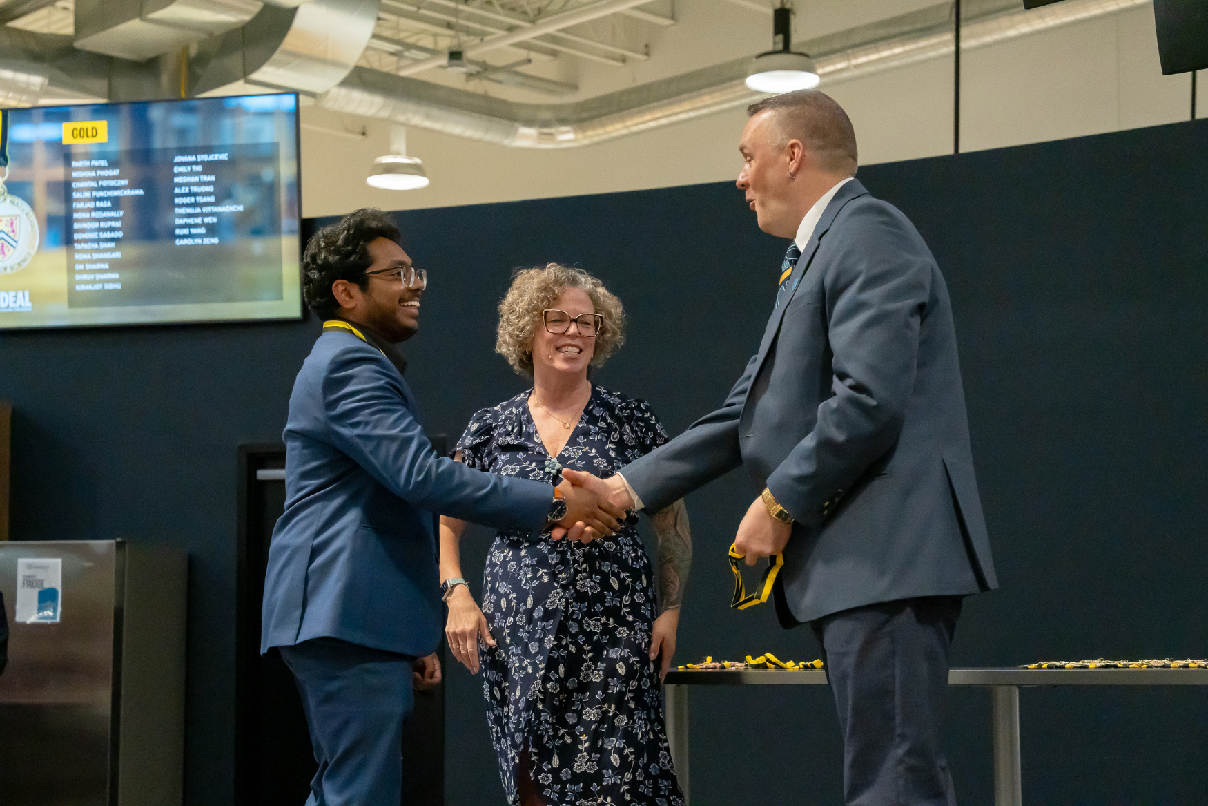 Professor Graham Murphy shaking a students hand at the IDEAL Scholar ceremony