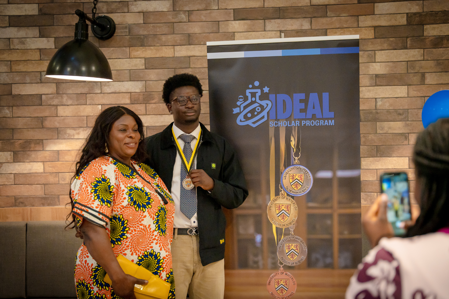 A student with his family at the IDEAL Scholar ceremony.