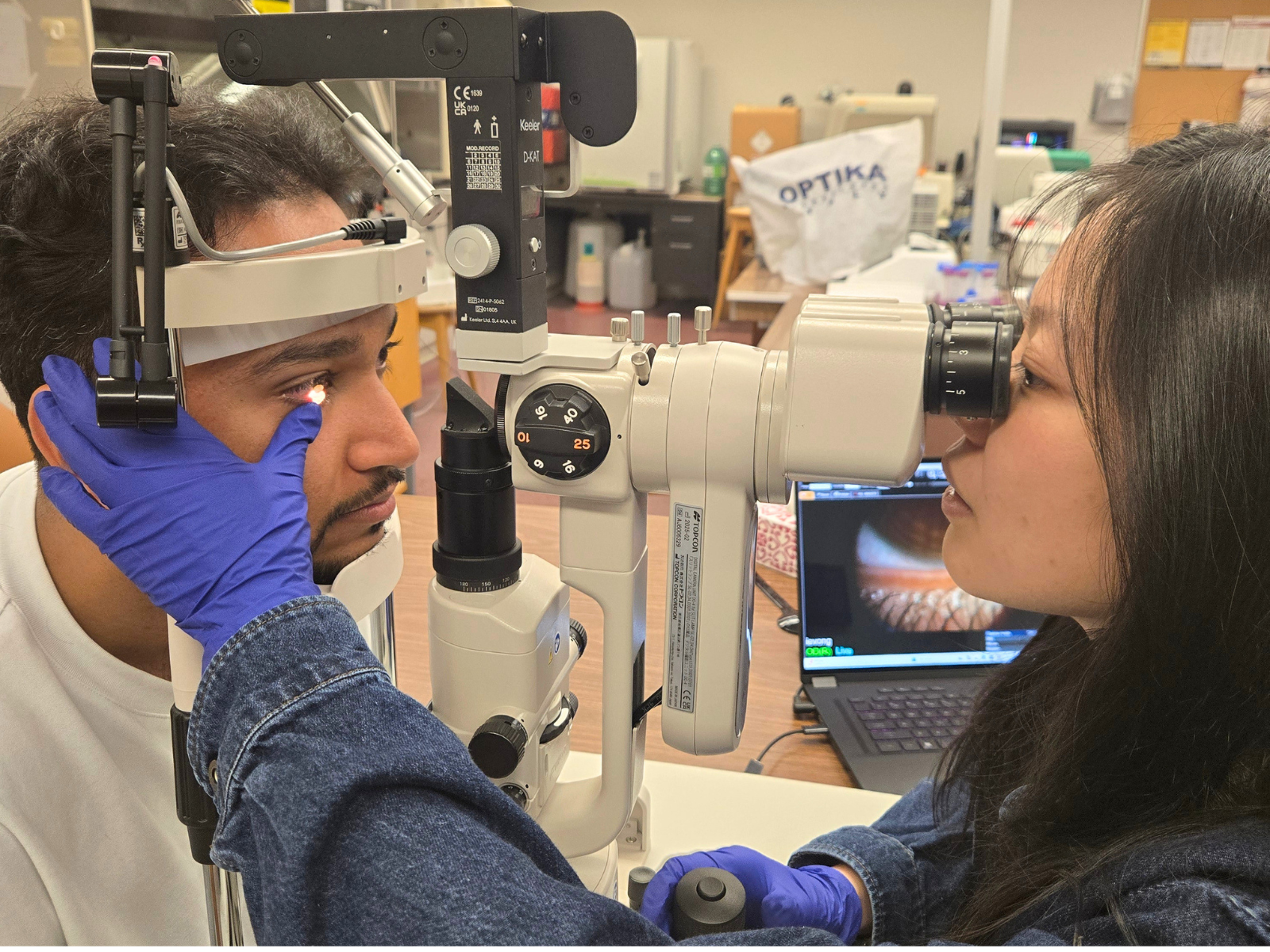 Ivy Vong examining eye in lab