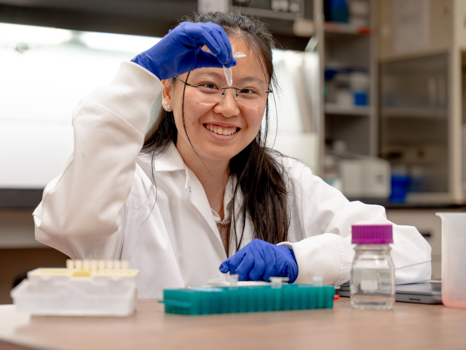 Ivy Vong holding up science lab equiptment