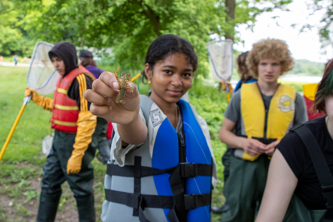 Student proudly showing off a bug they collected.