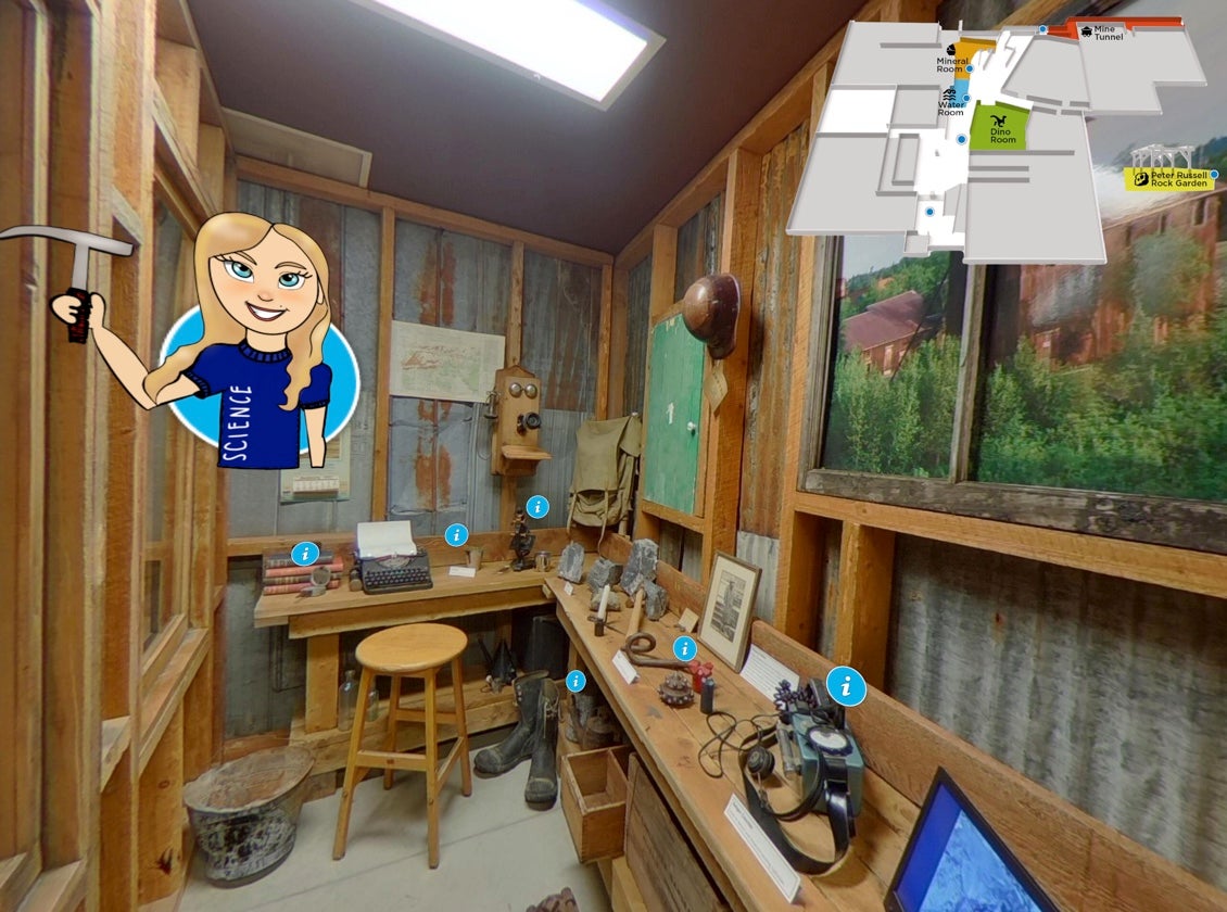 Inside the mining tunnel office. Blue dots indicate places with more information and a cartoon tour guide holds a rock hammer