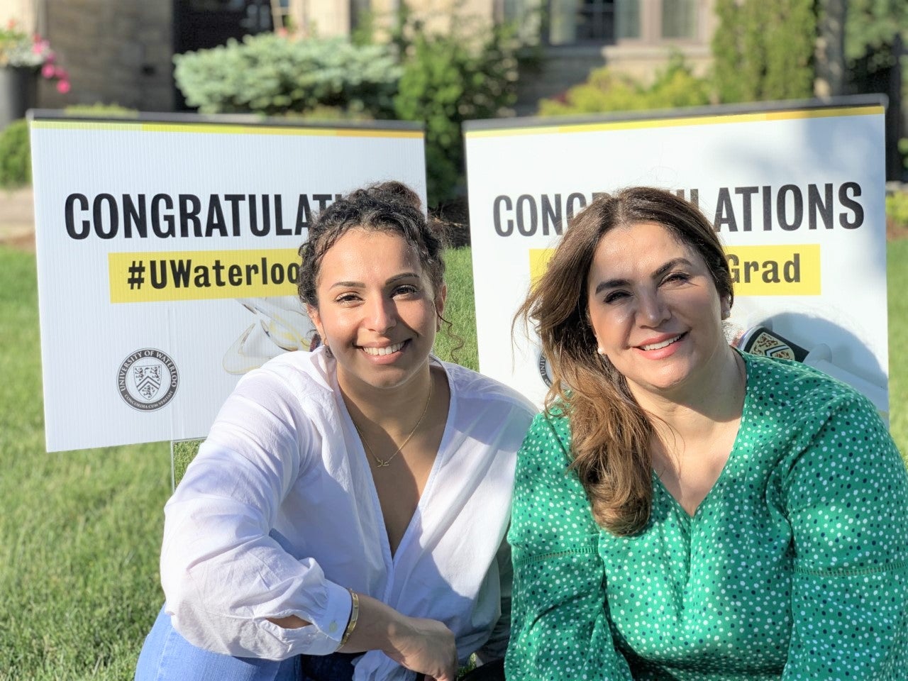 Ola Elkhatib and Abir Khaled in front of their UWaterloo convocation lawn signs