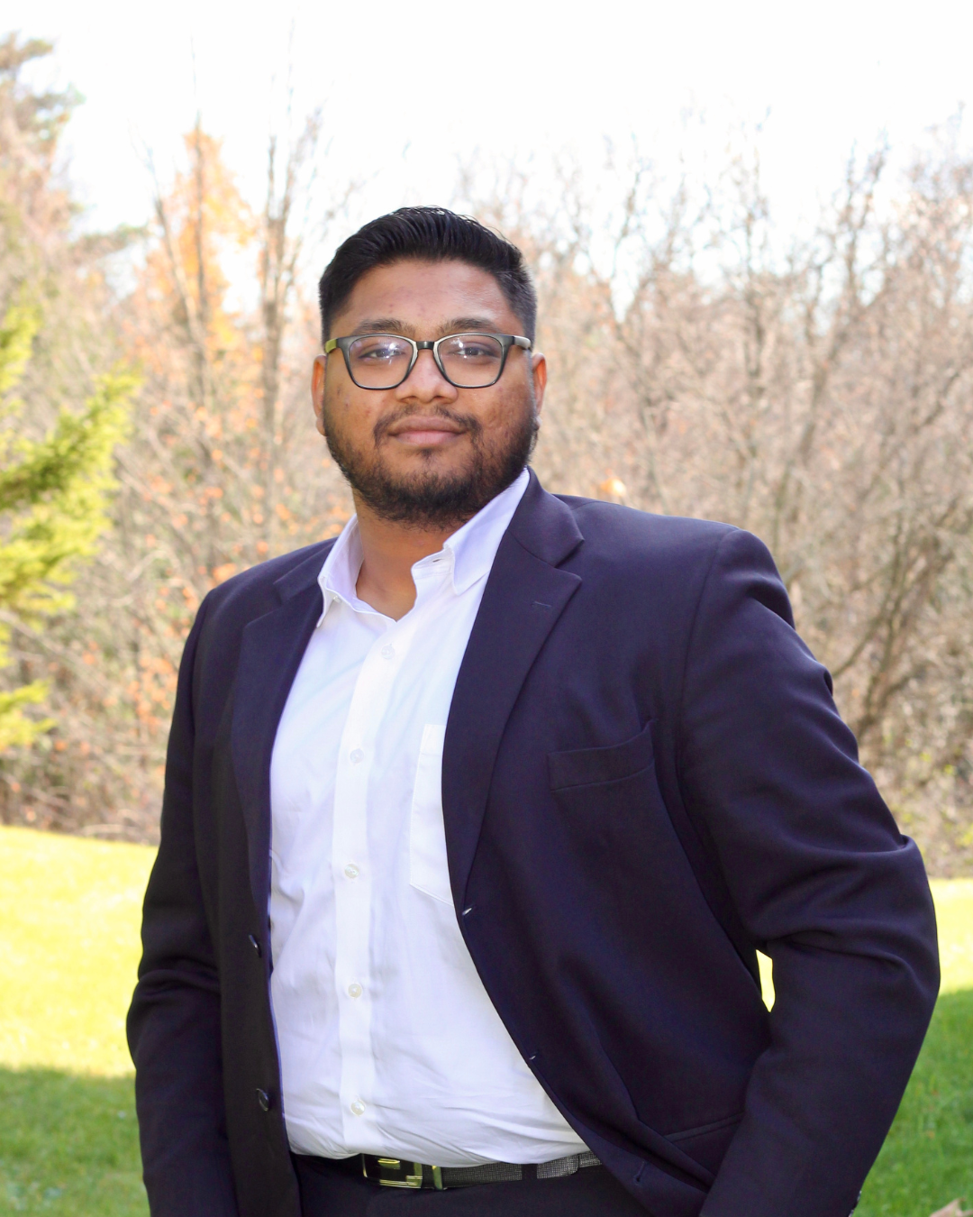 Parth outside wearing a white collared shirt and black blazer.