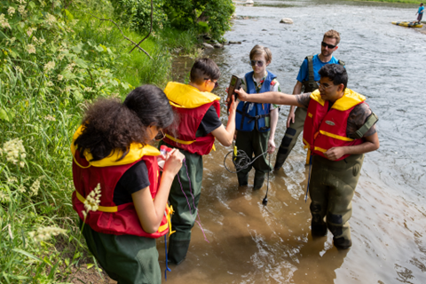 Students and instructors getting ready to enter the water.