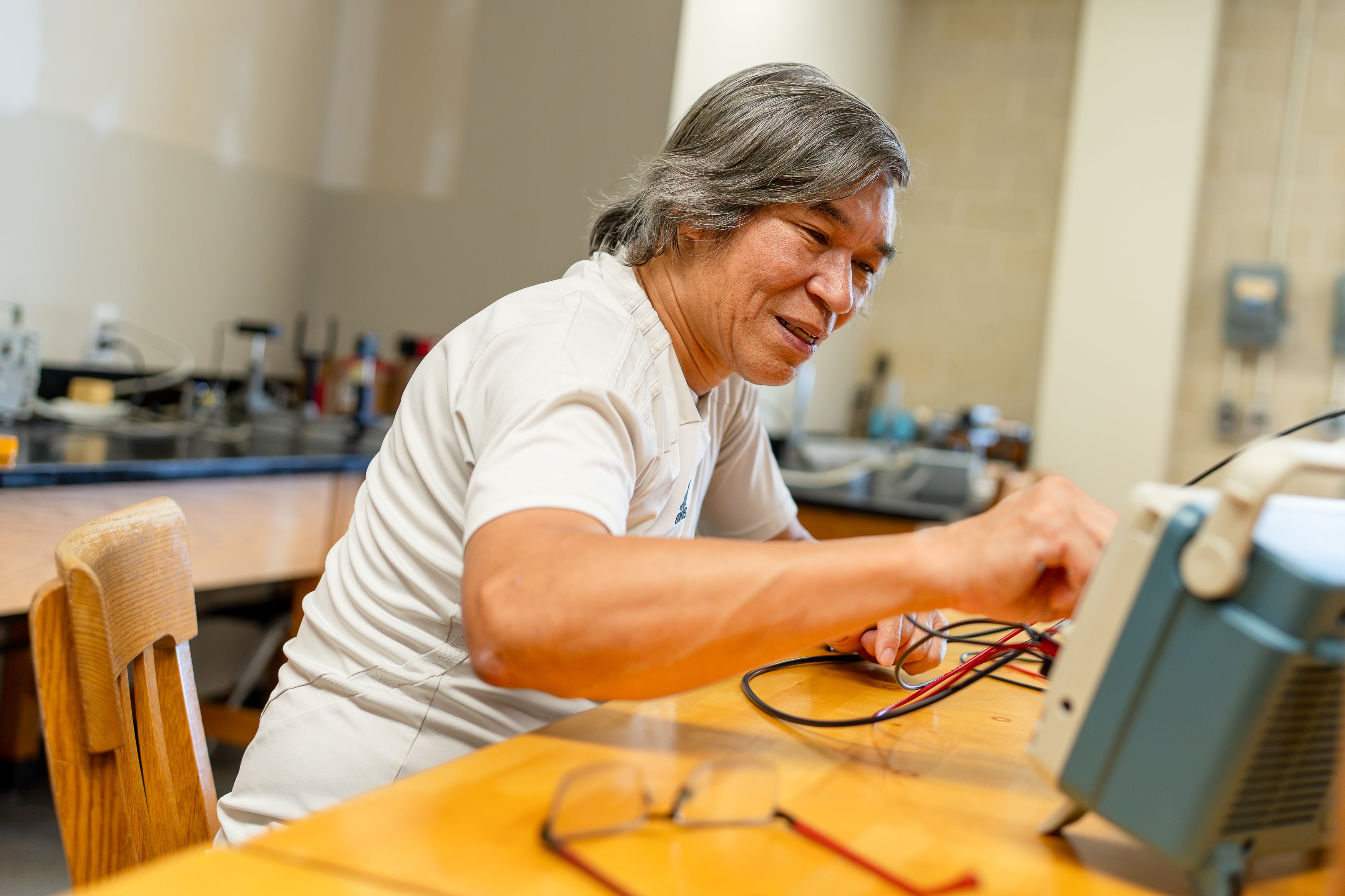 Dinh working with equipment in the lab. 