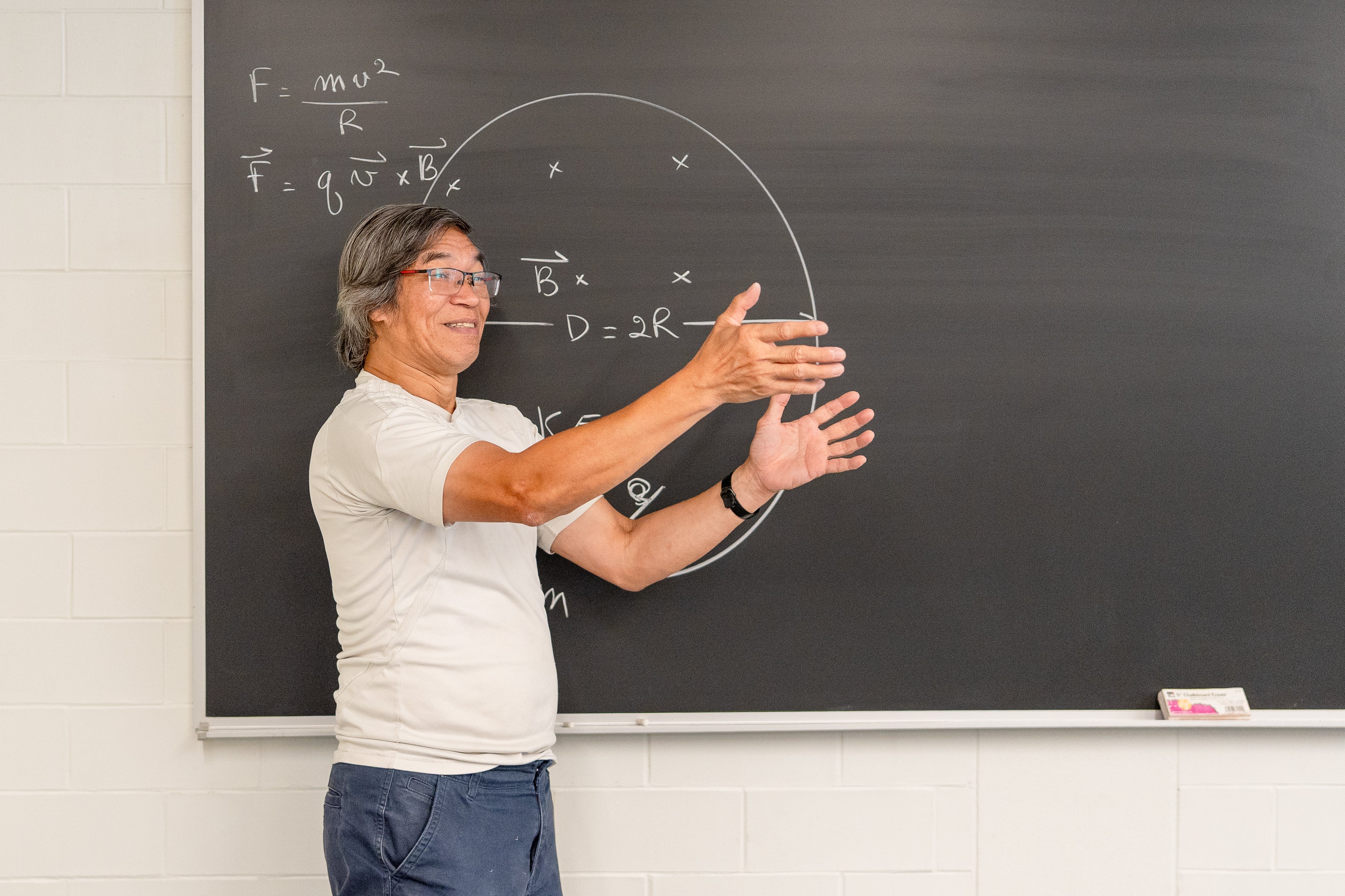 Tan Dinh at a chalkboard. 
