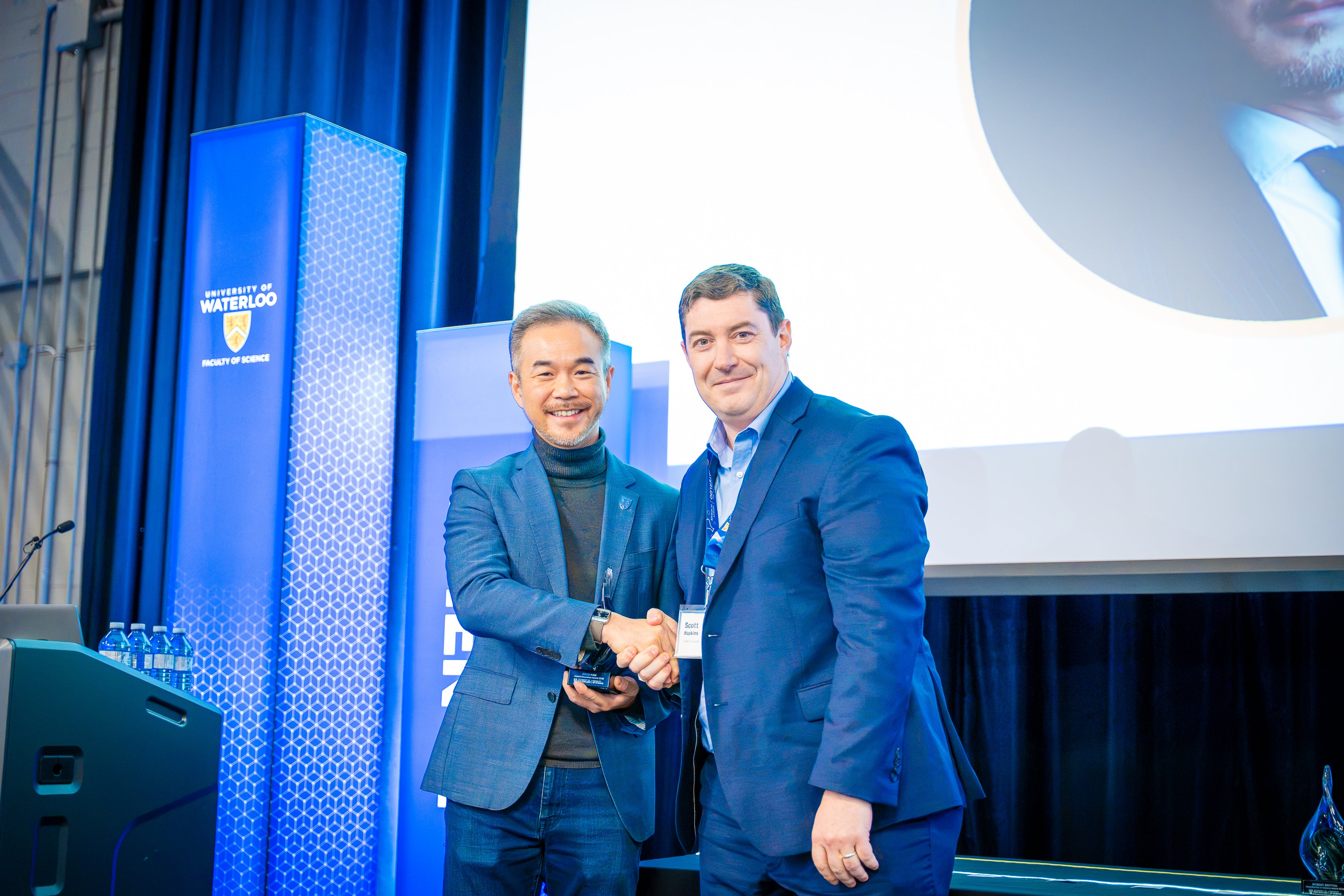 Scott Hopkins presenting Joe Han with his award
