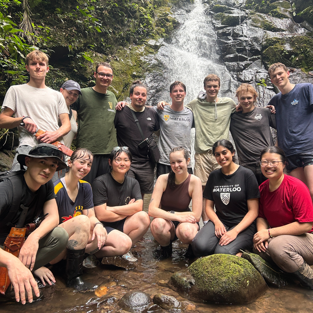 A group of waterloo Science students at a waterfall in Costa Rica.