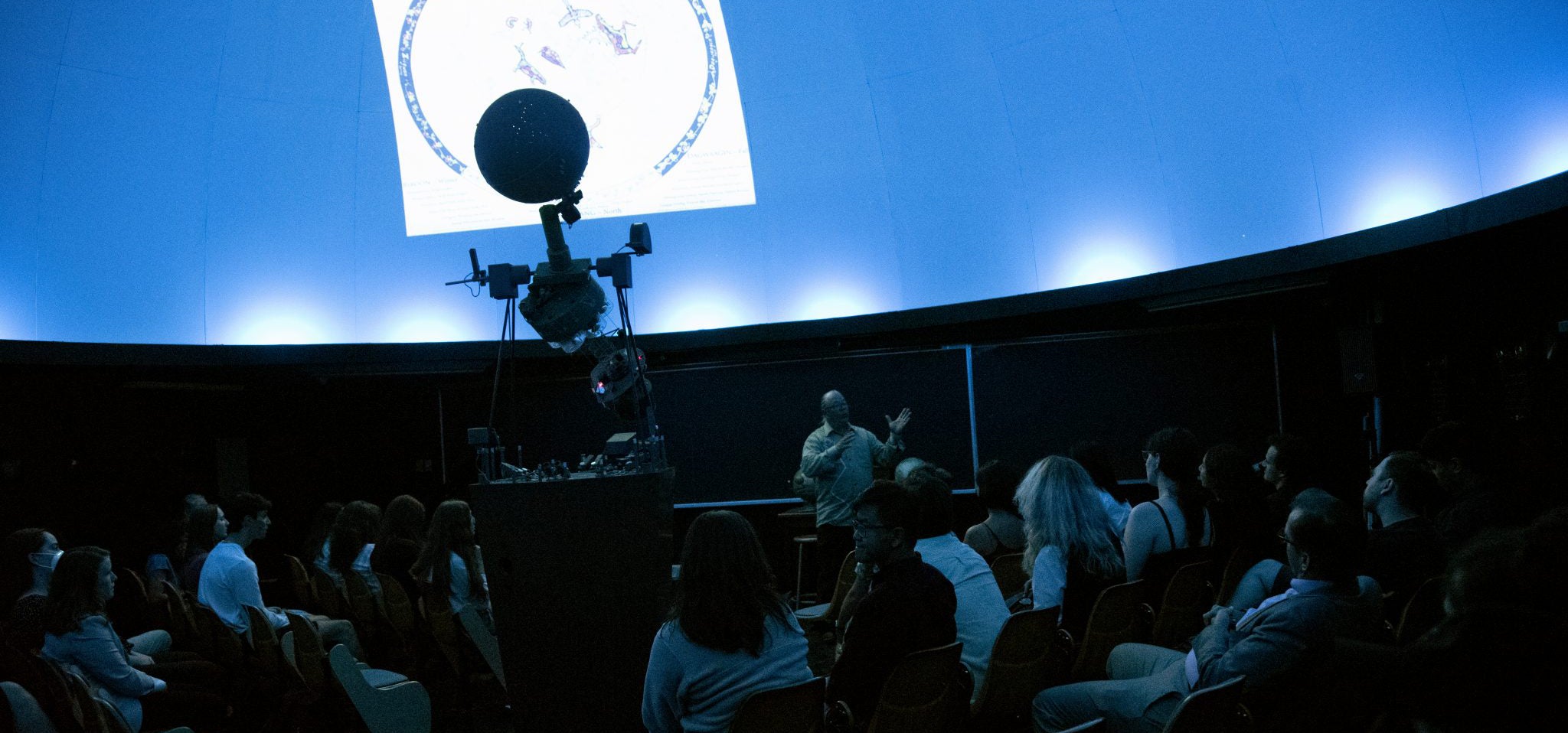 audience watching planetarium show