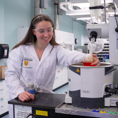 A chemistry student conducting an experiment in a lab