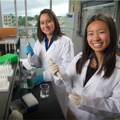 Pharmacy students smiling in the lab
