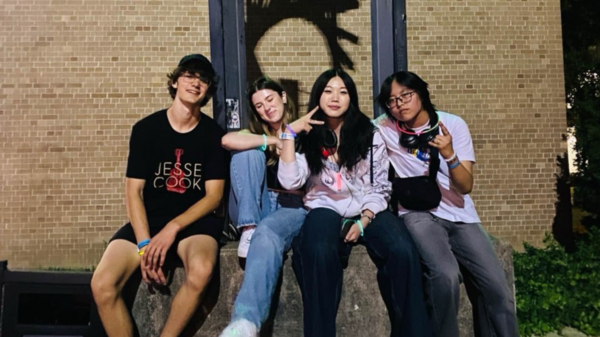 Dorathy and friends enjoying the first week on campus at Waterloo. They are sitting on a cement block posing.
