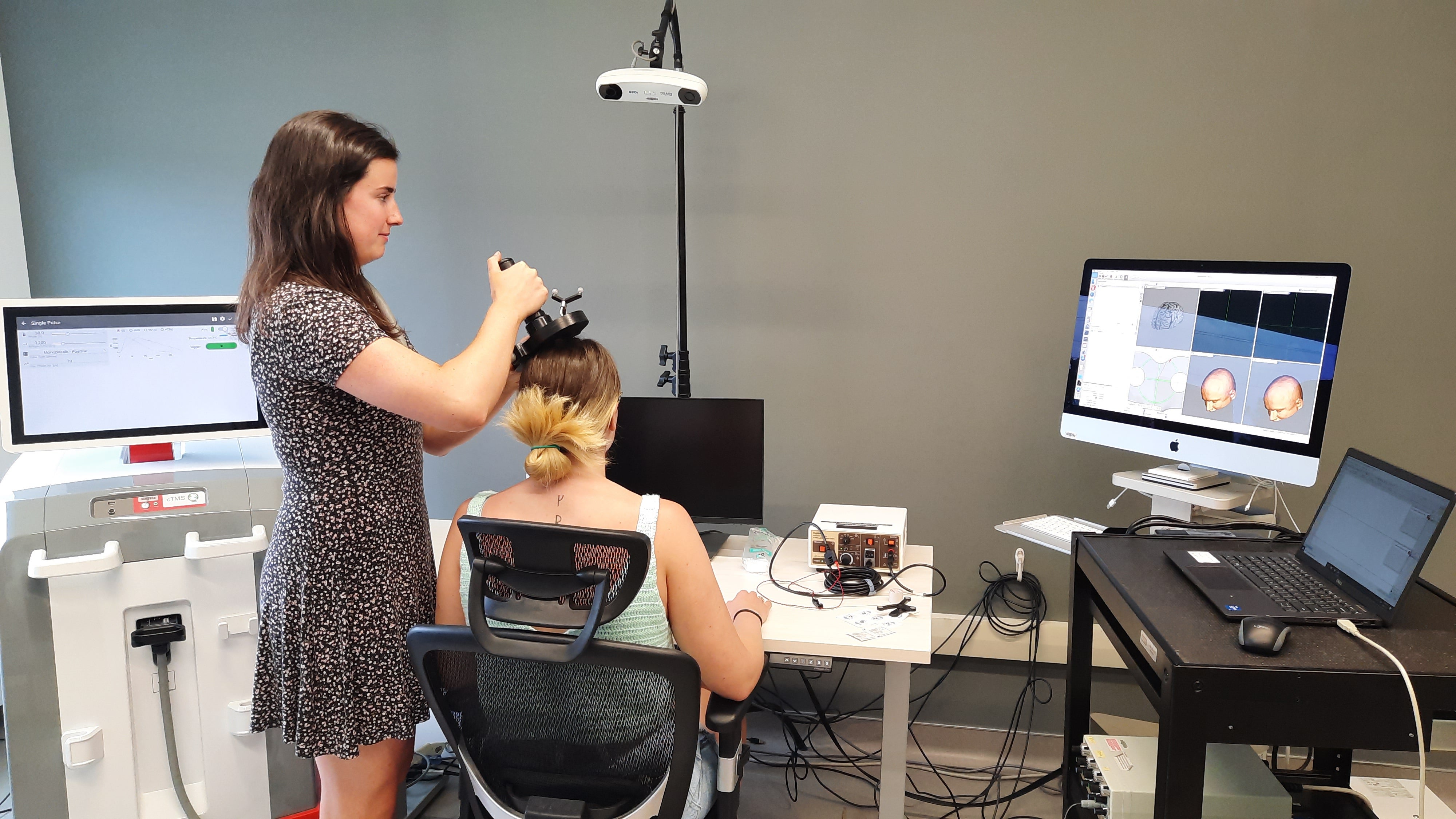 Sensorimotor Control and Learning Lab member performing transcranial magnetic stimulation