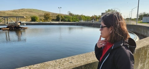 Diana Cardenas Soraca overlooking a wastewater treatment plant