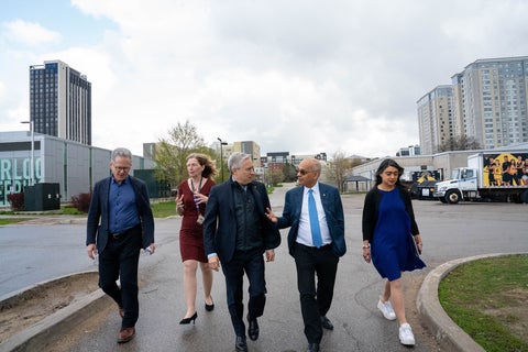 Vivek, Bardish Chaggar and others walking and talking outside