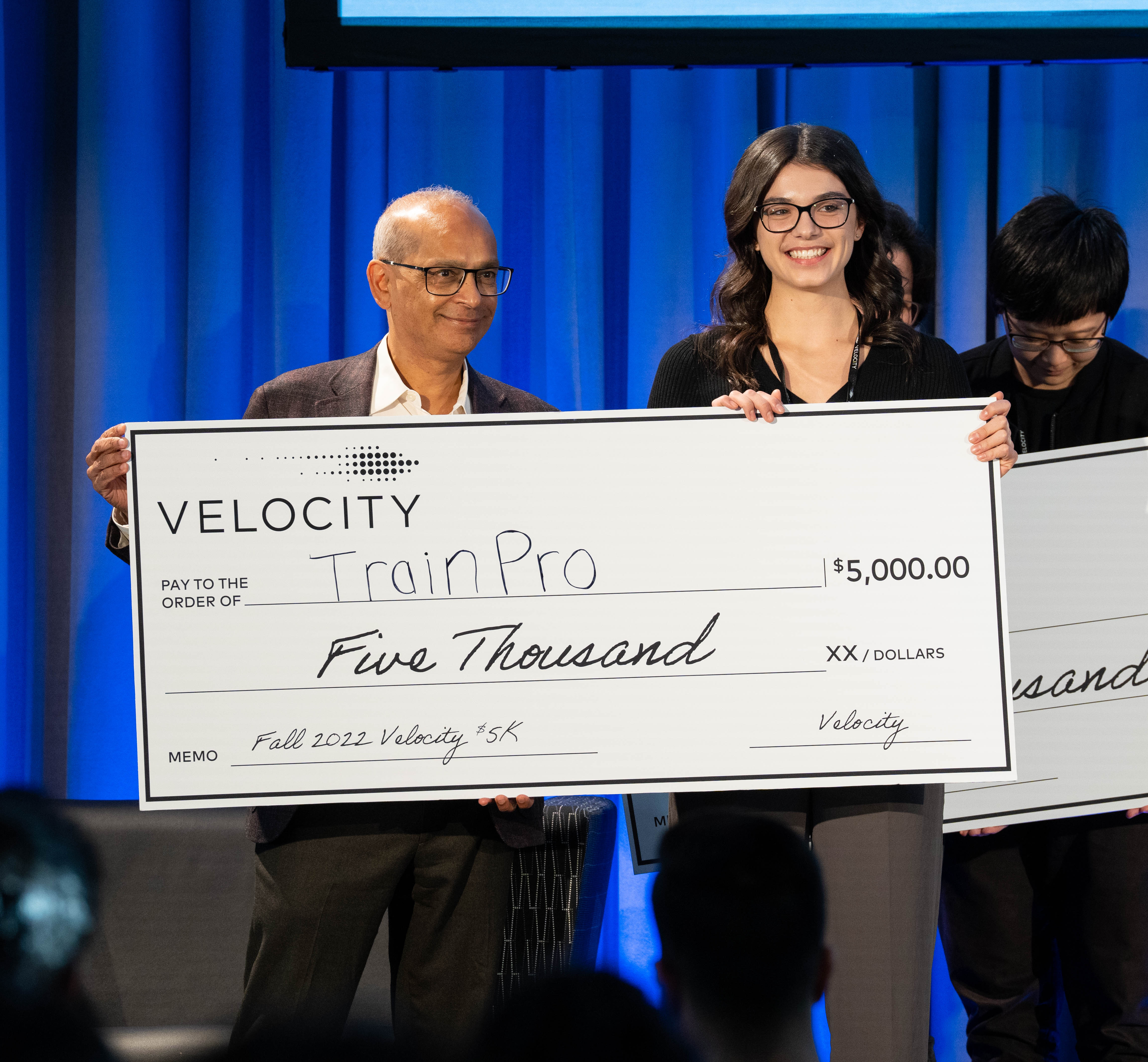 Vivek presenting a student with a novelty cheque
