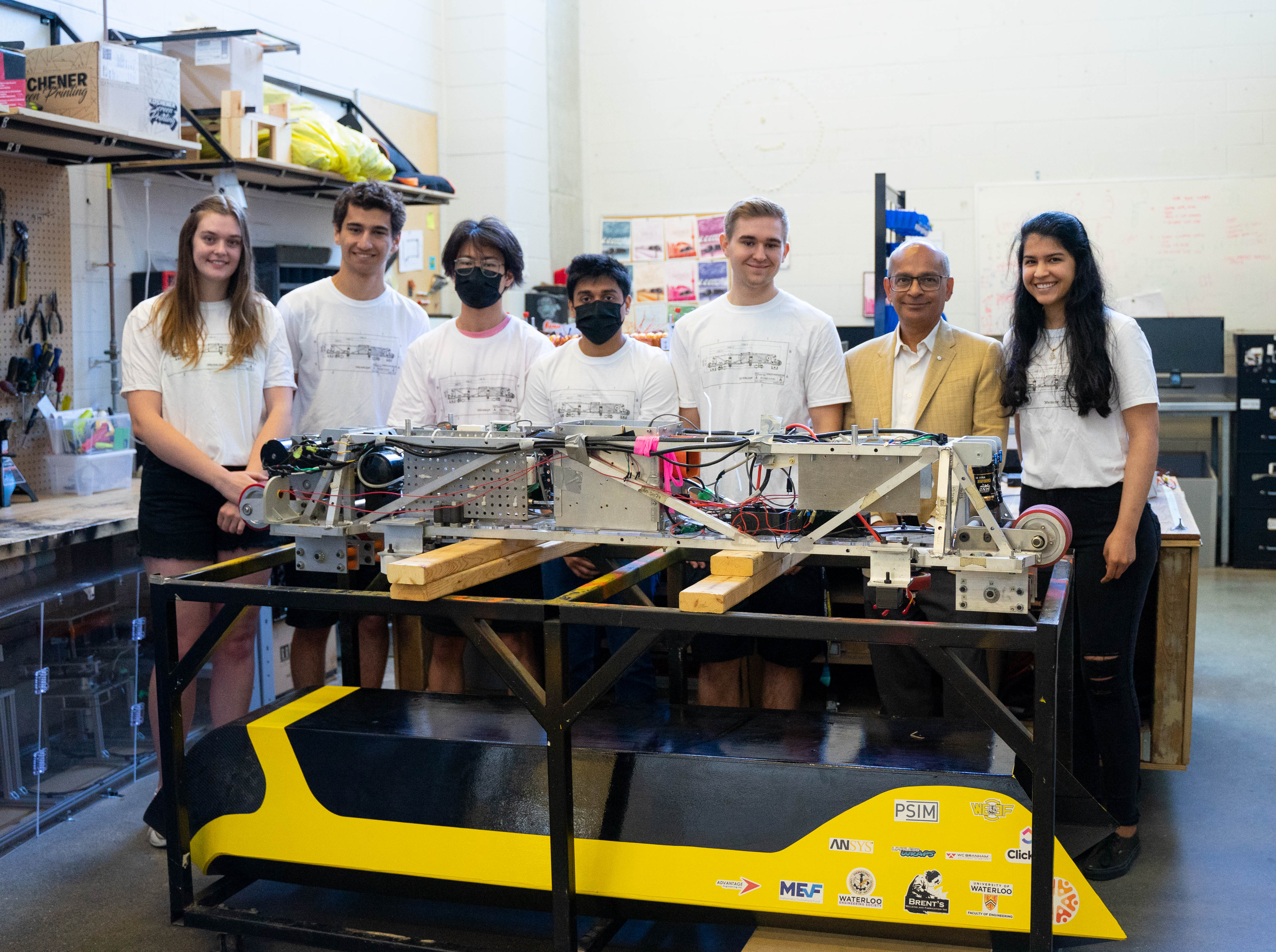 students standing in front of a project