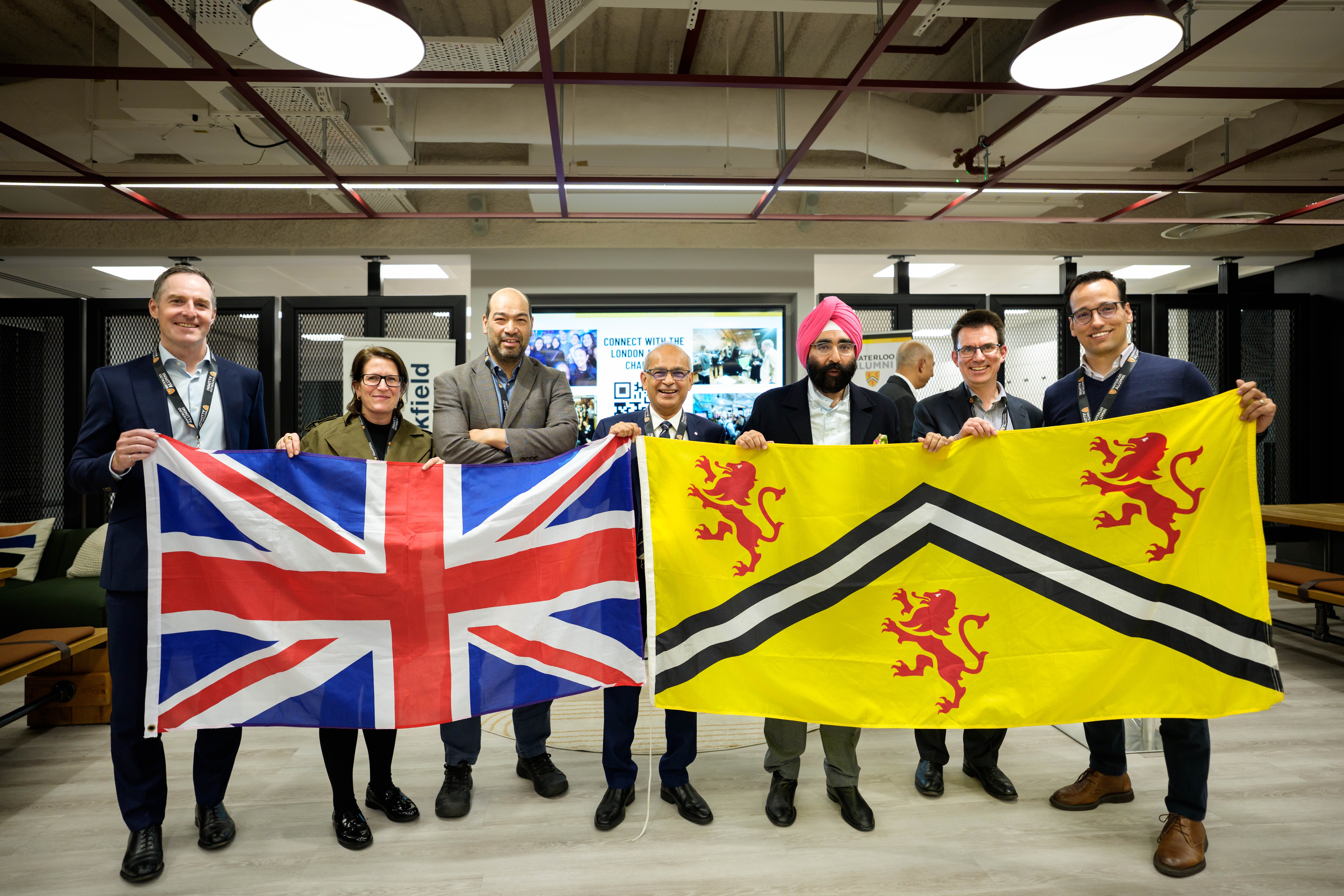 Vivek and others holding up a UK flag and a UW flag