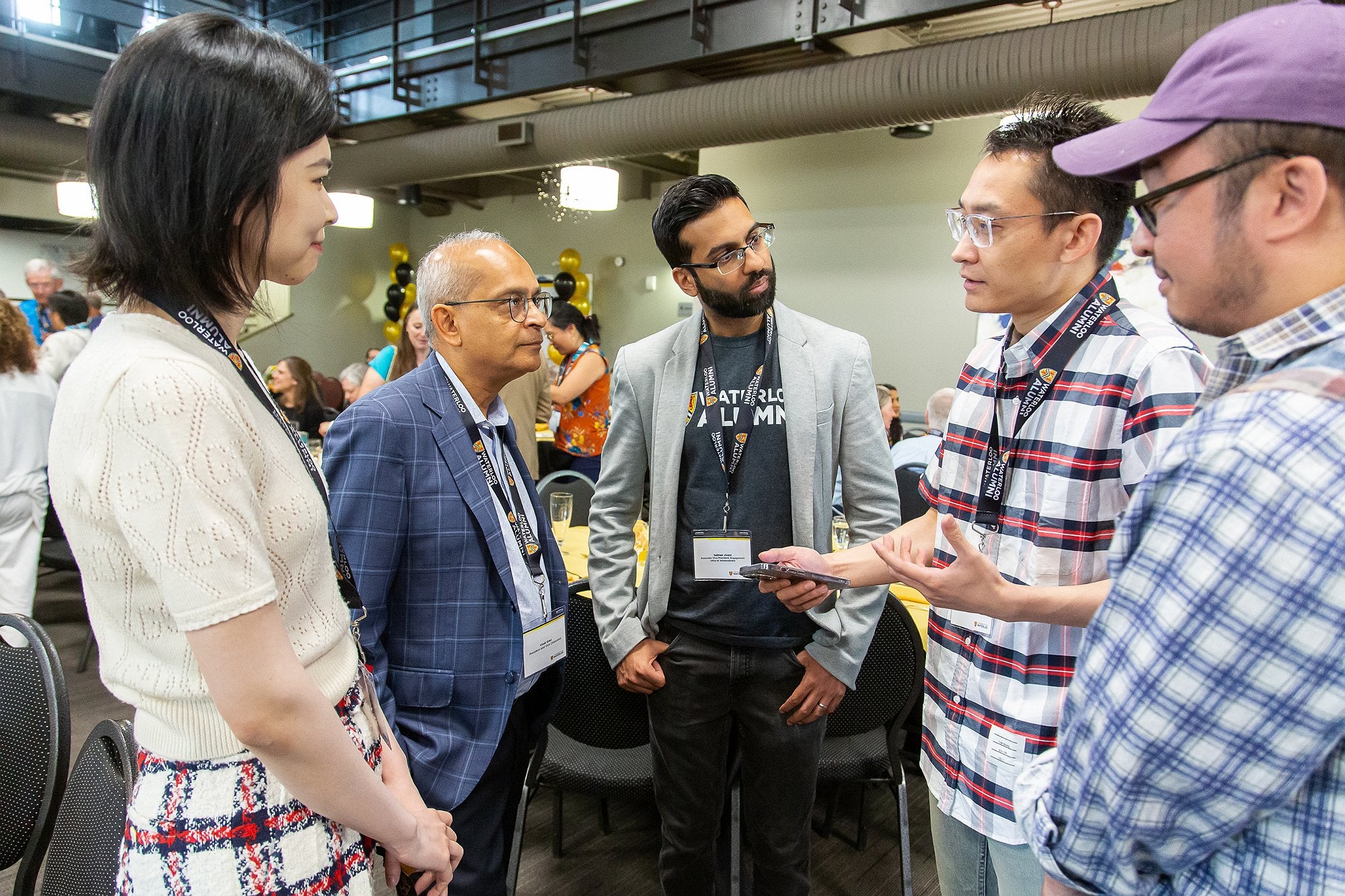 Vivek surrounded by researchers chatting