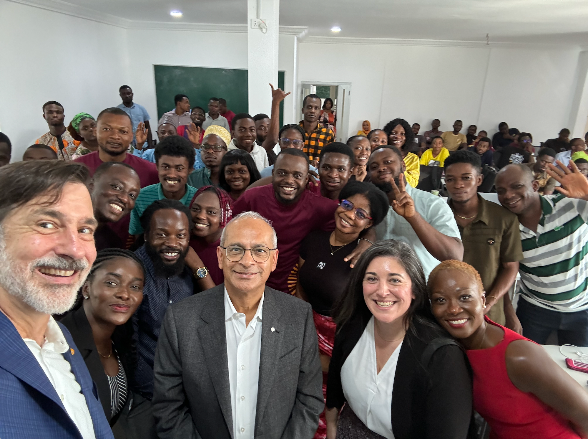 Vivek standing with lots of folks in the country of Ghana