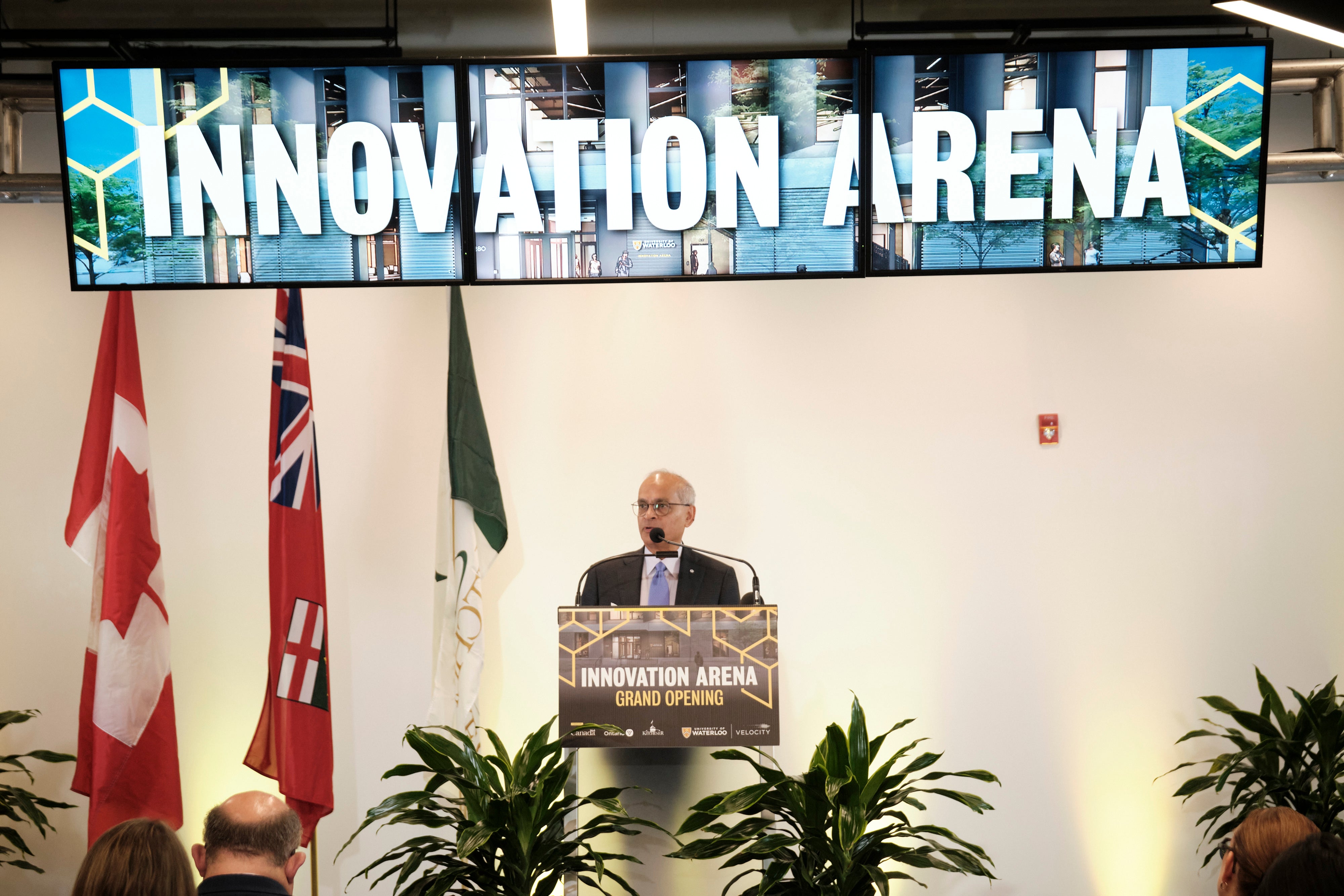 Vivek Goel standing beneath a sign saying Innovation Arena