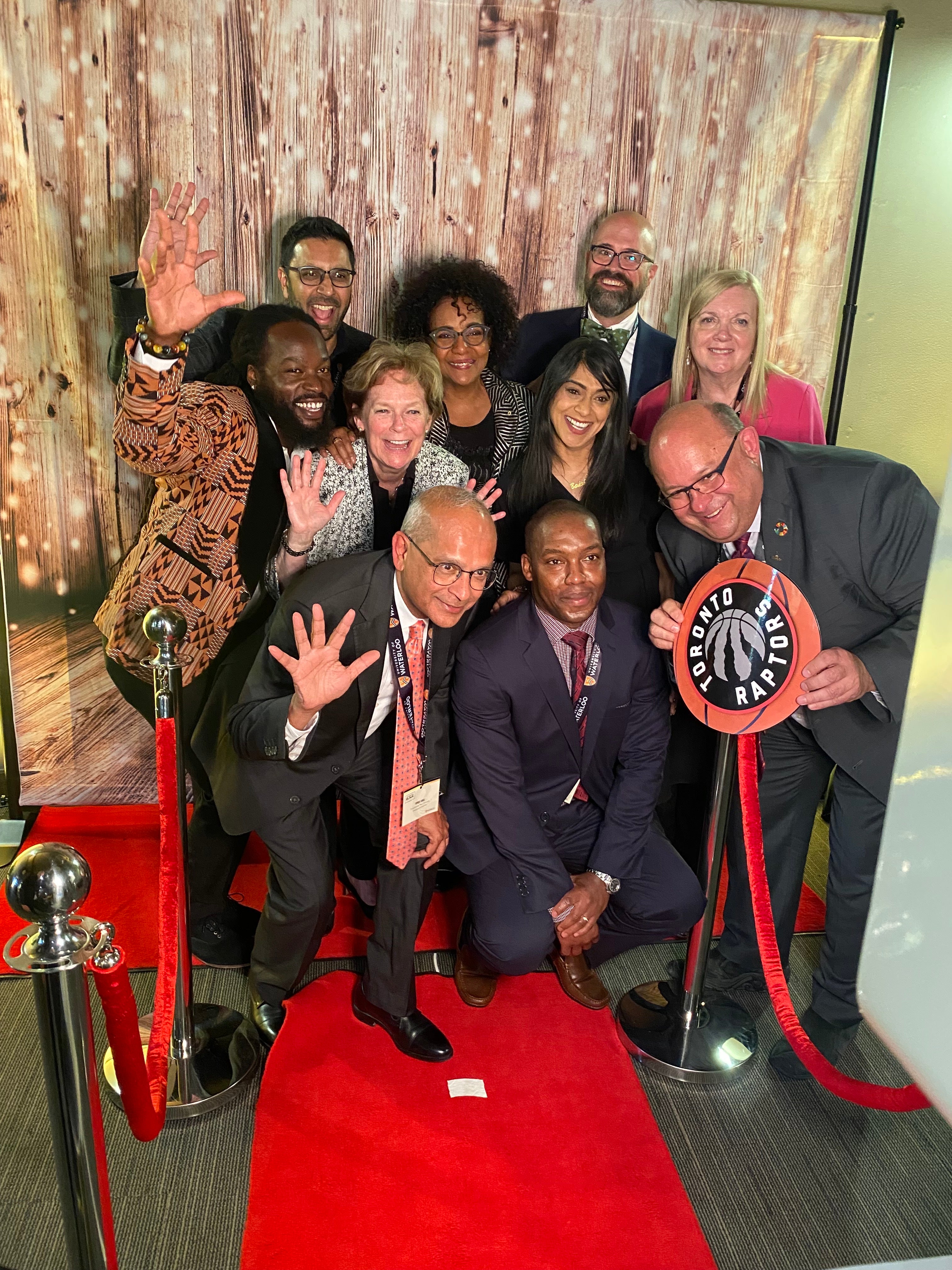 Vivek in a fun group photo-booth style photo surrounded by staff and government leaders