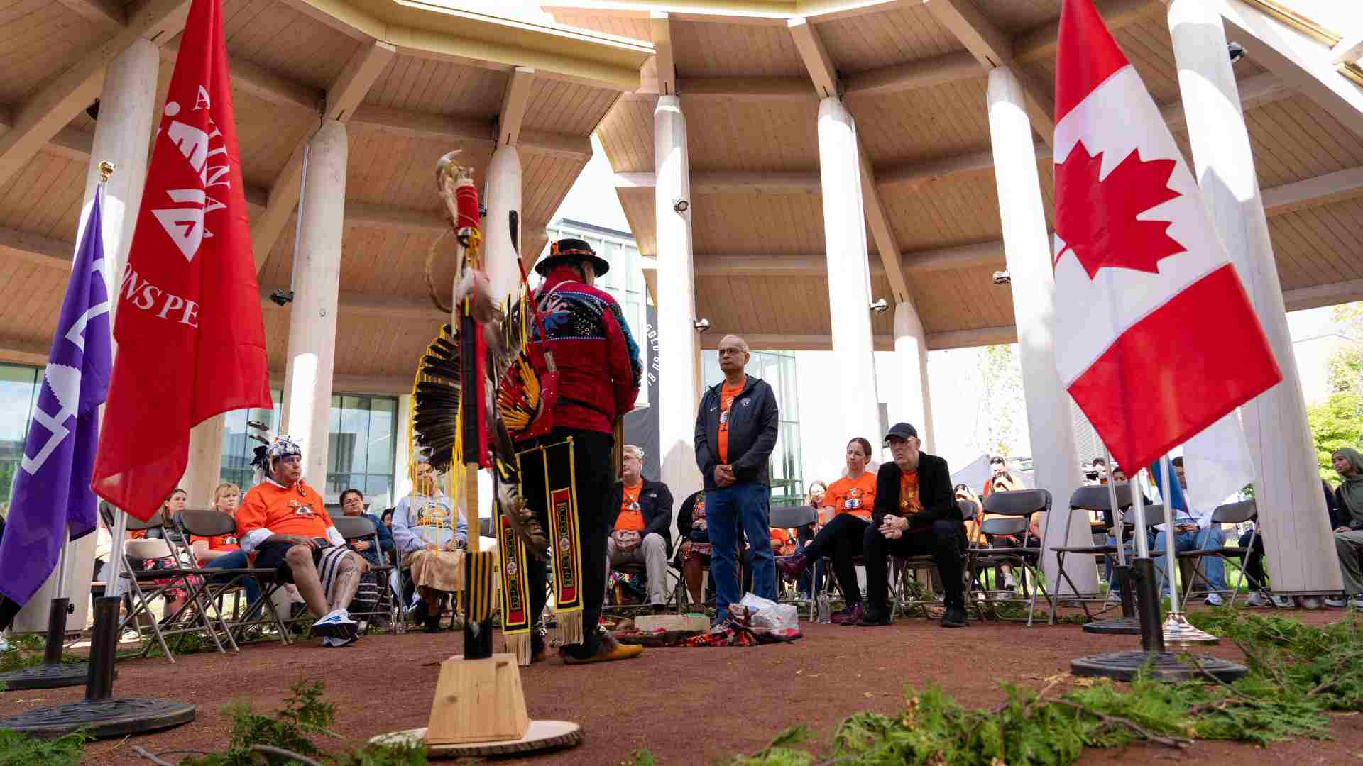 Vivek standing in the centre of an indigenous gather space