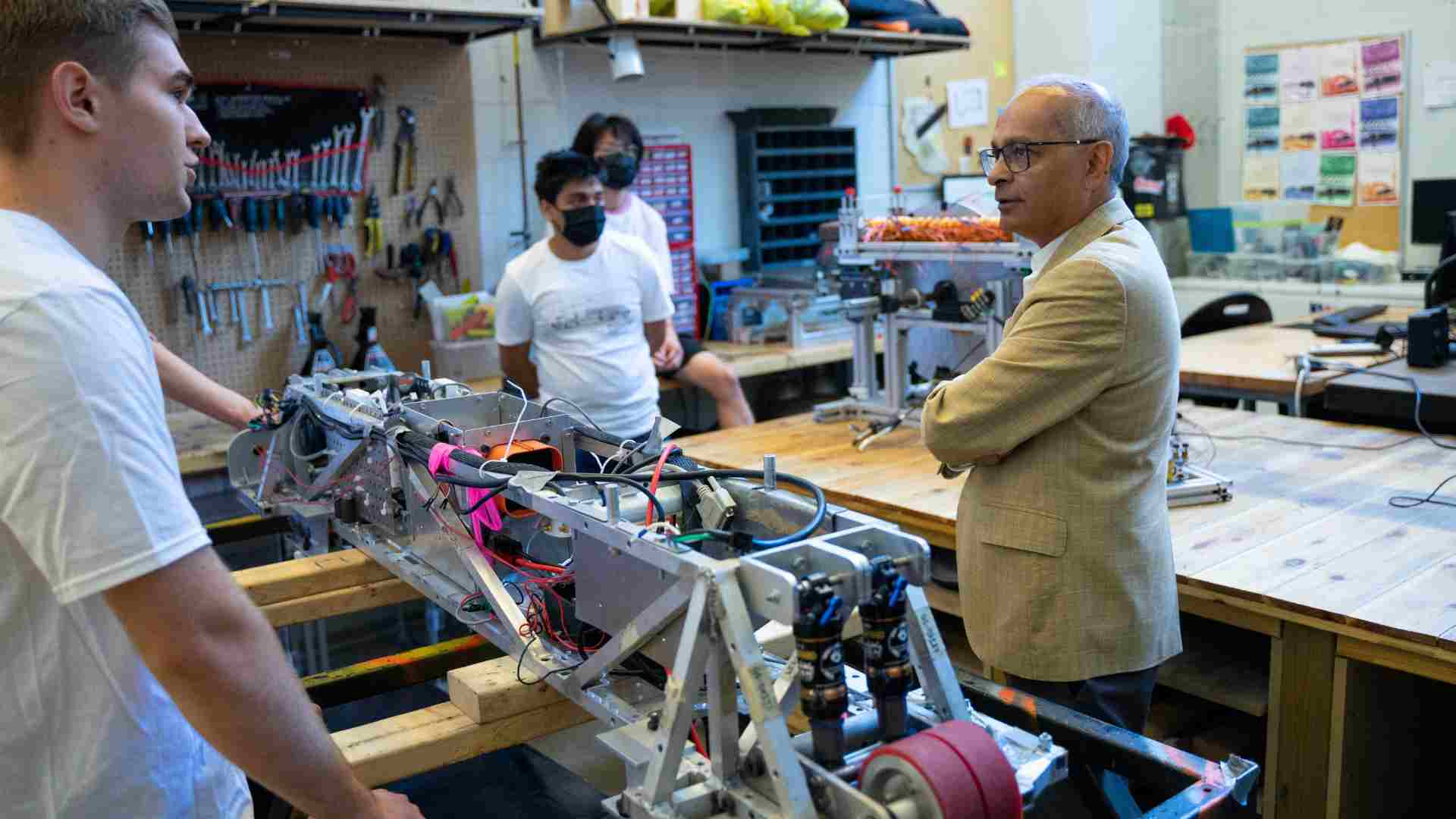 Vivek standing amongst researchers