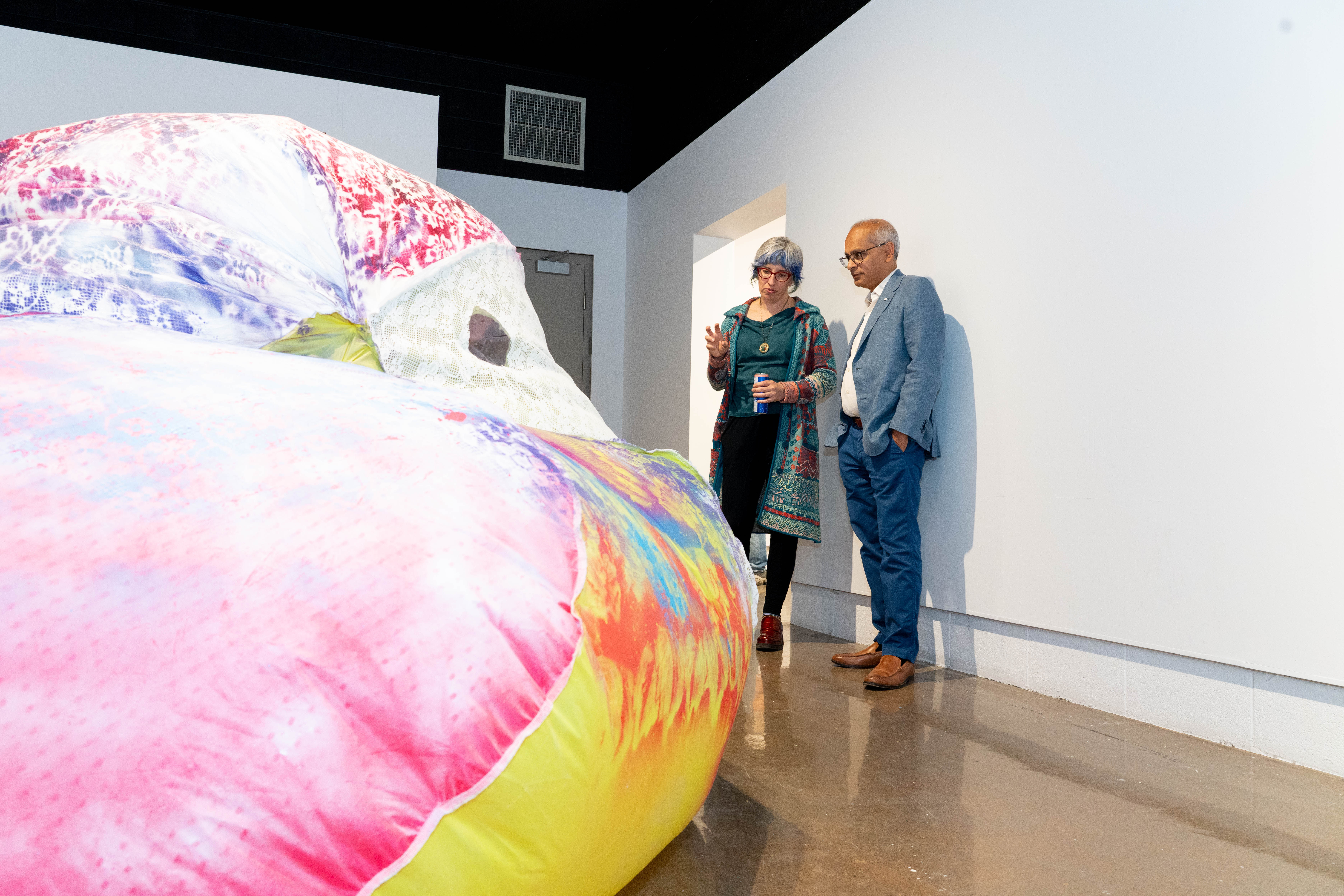 Vivek Goel discussing a piece of art with an artist
