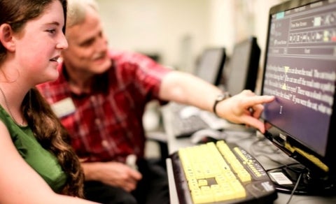 High technology assessor showing client Zoomtext on a computer monitor.