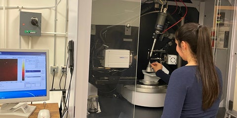 Graduate student is operating the Kappa Bruker diffractometer.