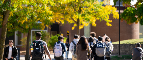 back view of Waterloo students walking through campus in the fall 