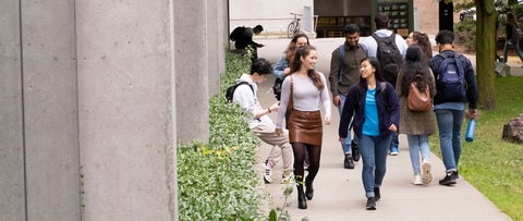 Waterloo students walking through the pathway beside Quantum Nano Centre