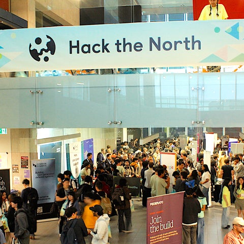 Students gathering in the Engineering building foyer with Hack the North banner at the top