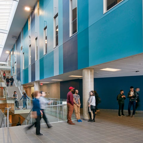 Students walking around the main lobby of the Science Teaching Complex building